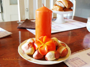 orange candle and painted stones centerpiece