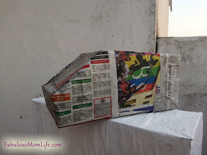 cardboard box ambulance shape newspaper covered