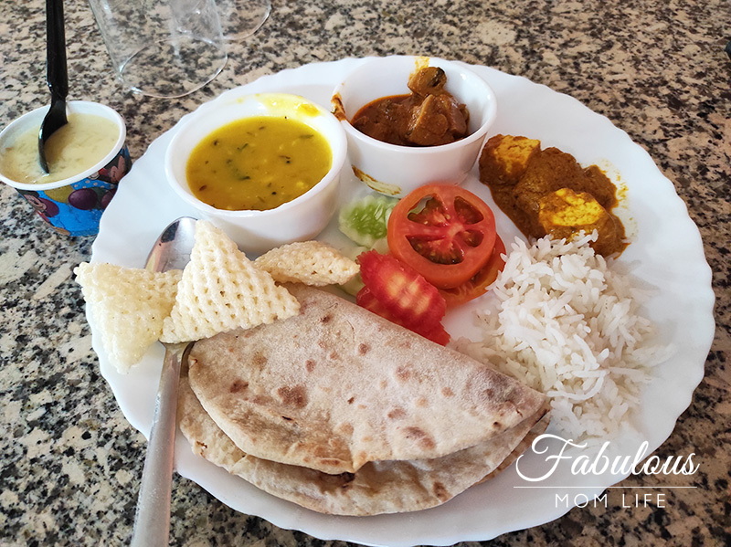 Indian Dinner Thali with Paneer Butter Masala, Mushroom Masala, Dal Fry, Roti, Rice