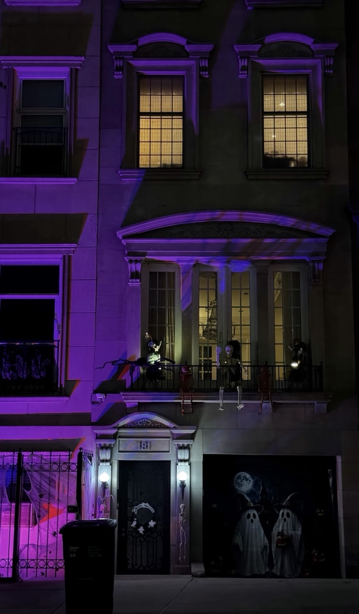 Purple-lit townhouse at night - NYC Halloween Decorations