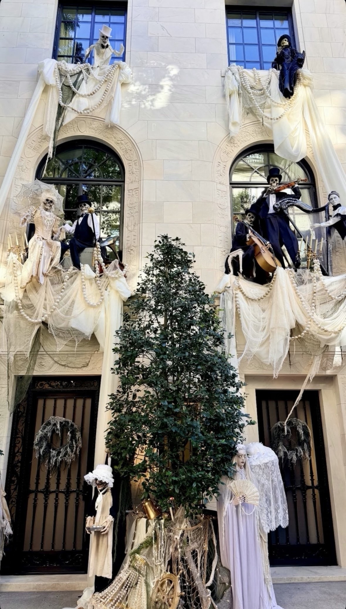 White-draped NYC townhouse with skeleton figures